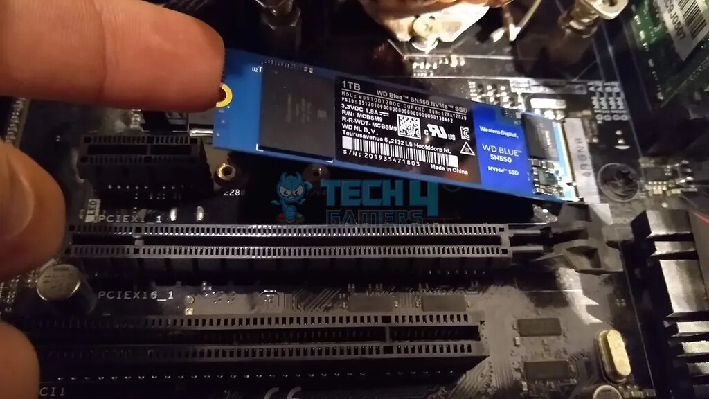 image showing Carefully Placing SSD on PC motherboard 