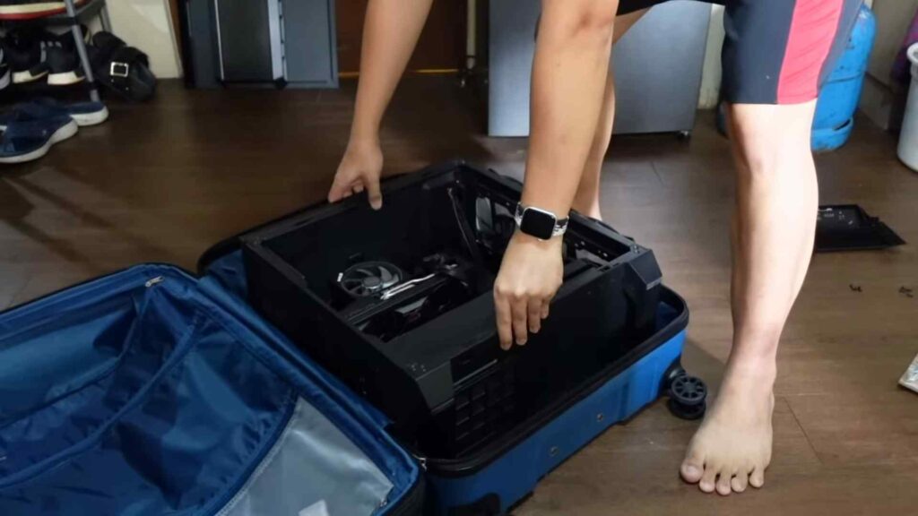 A PC Being Fitted Into A Luggage 